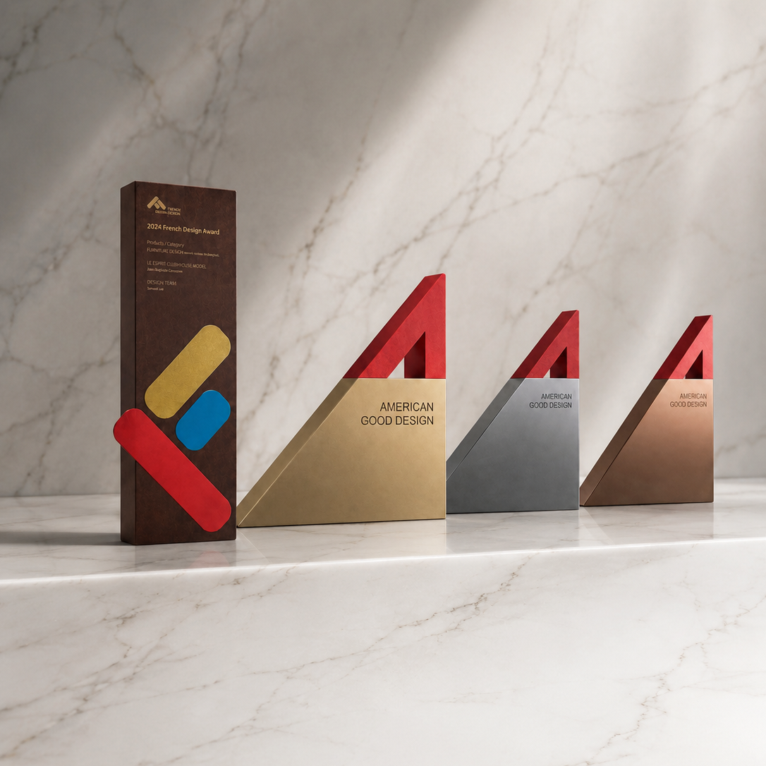 Four colorful design awards on a marble surface